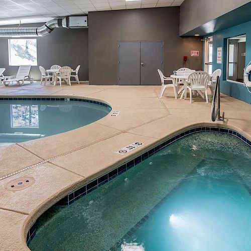 The image shows an indoor pool area with a hot tub, lounge chairs, tables, and a pool with a depth of 3 ft. 4 in. There is also a life preserver.